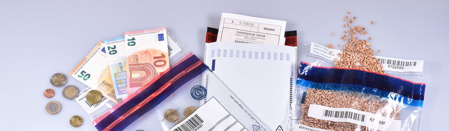 Geldscheine und Münzen in Umschlägen, die für Sicherheitsverpackungen und Manipulationsschutz verwendet werden.